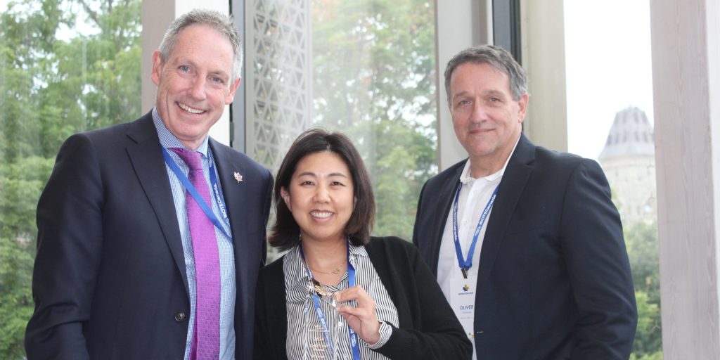 Andrew Casey, left, President & CEO, BIOTECanada, and Oliver Technow, right, BIOTECanada Board Chair and CEO, BioVectra Inc. present Christine Ha, CFO, Ventis Therapeutics, with the 'Gold Leaf Award' for most promising company at the BIONATION 2024 reception on Sept. 24 hosted by BIOTECanada at the National Arts Centre.