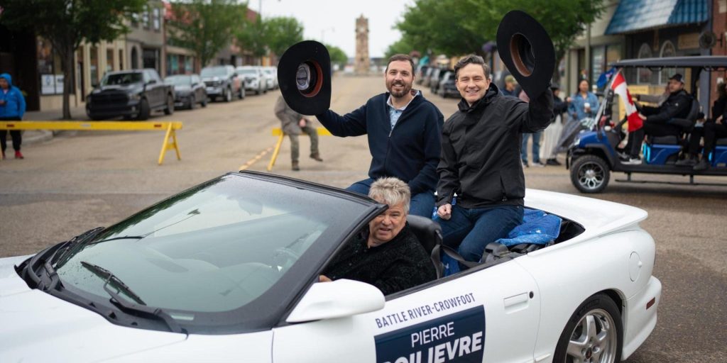 Now-former Conservative MP Damien Kurek, left, and Conservative Leader Pierre Poilievre campaigning in Battle River-Crowfoot, Alta., on June 22, 2025.