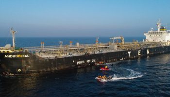 Greenpeace activists paint ‘peace not oil’ on the side of a tanker transporting oil from Russia to Poland in March 2022. Greenpeace photograph courtesy of Flickr