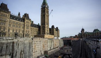 Centre Block towers over the pit where the new visitors’ centre will be builng during a media tour of the ongoing Centre Block rehabilitation project on  Nov. 14, 2024. The Hill Times photograph by Andrew Meade