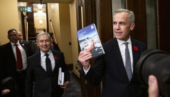 Prime Minister Mark Carney and Minister of Finance and National Revenue François-Philippe Champagne take the 2025 budget into the House of Commons to table iton  Nov. 4, 2025. The Hill Times photograph by Andrew Meade