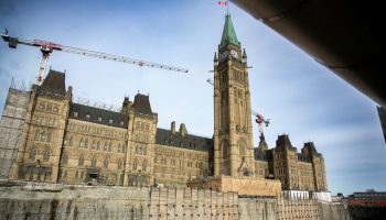 Centre Block towers over the pit where the new visitors’ centre will be builng during a media tour of the ongoing Centre Block rehabilitation project on  Nov. 14, 2024. The Hill Times photograph by Andrew Meade