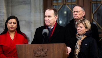 Minister of Employment, Workforce Development and Labour Steven MacKinnon scrums after a cabinet shuffle at Rideau Hall in Ottawa on Dec. 20, 2024. (Ruby Sahota, left, MacKinnon, David McGuinty, and Elisabeth Brière.) The Hill Times photograph by Andrew Meade