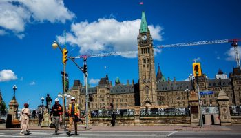 People cross Wellington Street at Parliament Hill on  May 30, 2024.