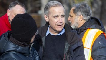 Liberal leadership candidate Mark Carney speaks with community members as he visits he Riveriew Park Winter Carnival in Ottawa’s Riverview Park neighbourhood on Feb. 9, 2025. The Hill Times photograph by Andrew Meade