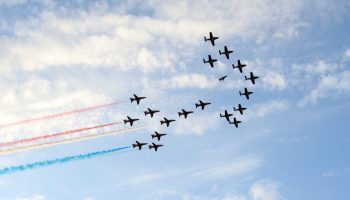 The Royal Air Force Aerobatic Team, the Red Arrows, performs a flypast over the new building. The Hill Times photograph by Sam Garcia