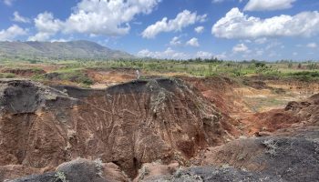 How flooding has carved deep gullies at the bottom of those slopes